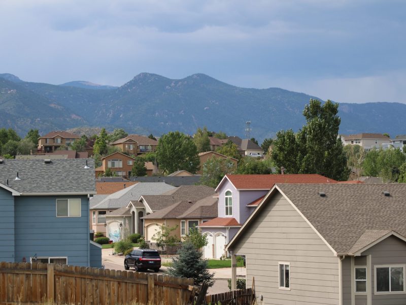 Suburban rooftops with the foothills west of Colorado Springs as a backdrop.